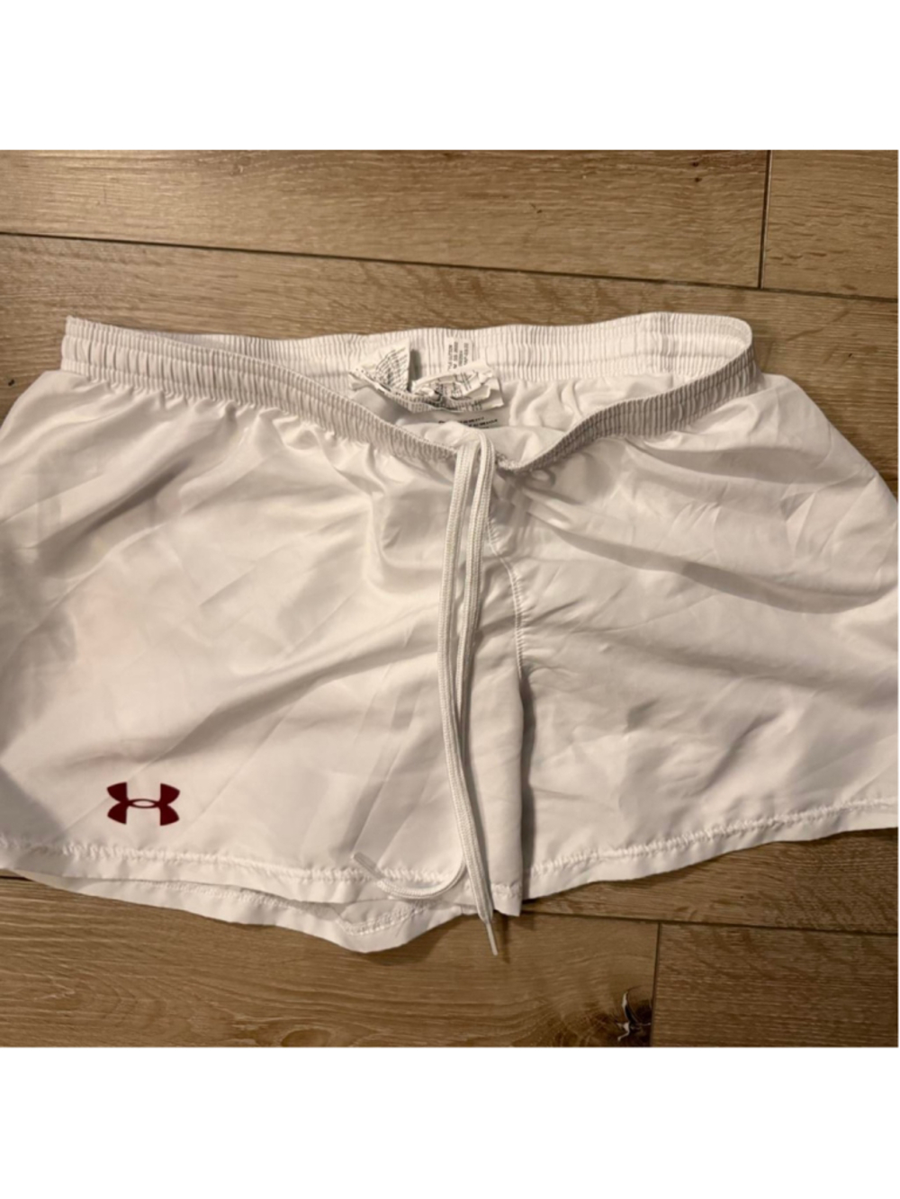 Under Armour white athletic running shorts with red UA logo, women’s size Large